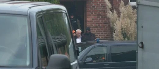 Police lead man from house